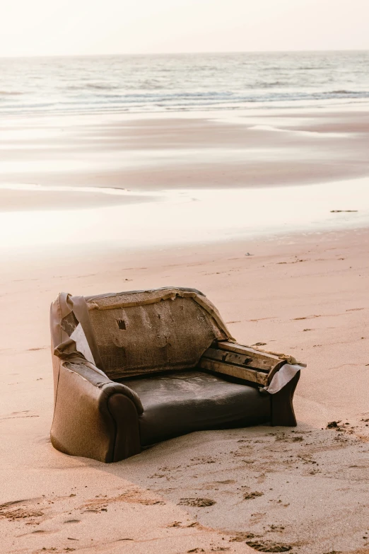 a lone chair is on the beach alone