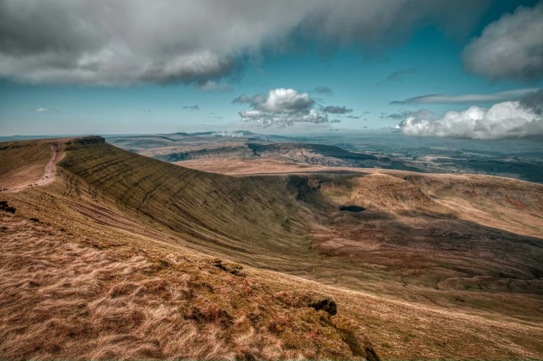 the mountains are divided by brown grass