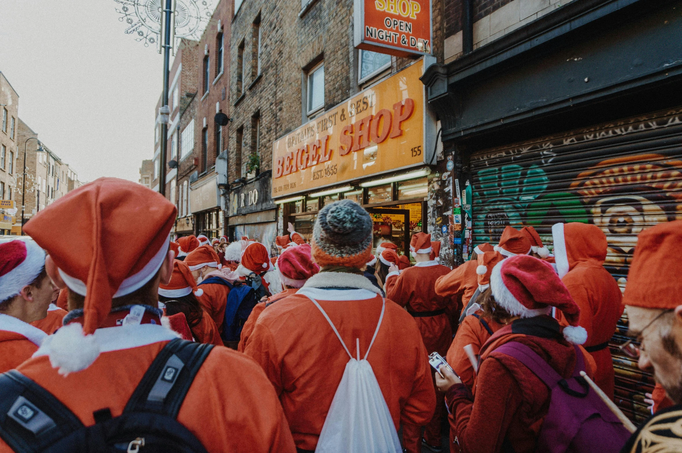 large group of people in red costumes walking down the street