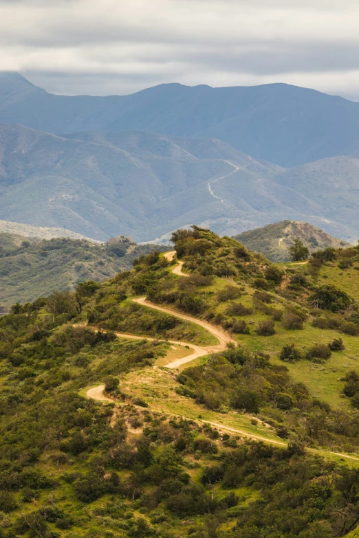 a dirt road is on the top of a mountain