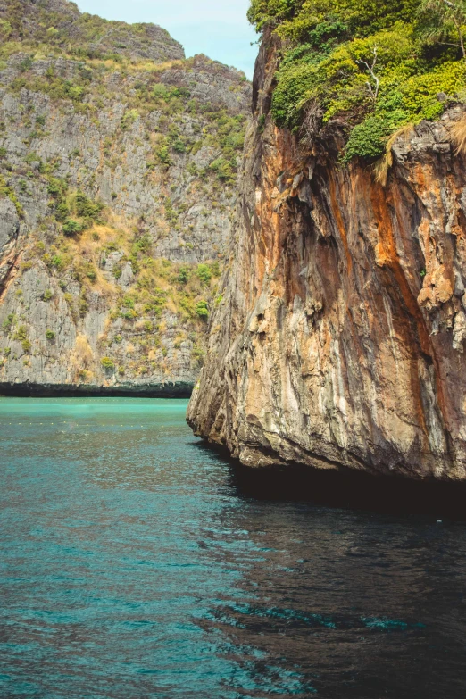 an island with rock formations near it on the ocean