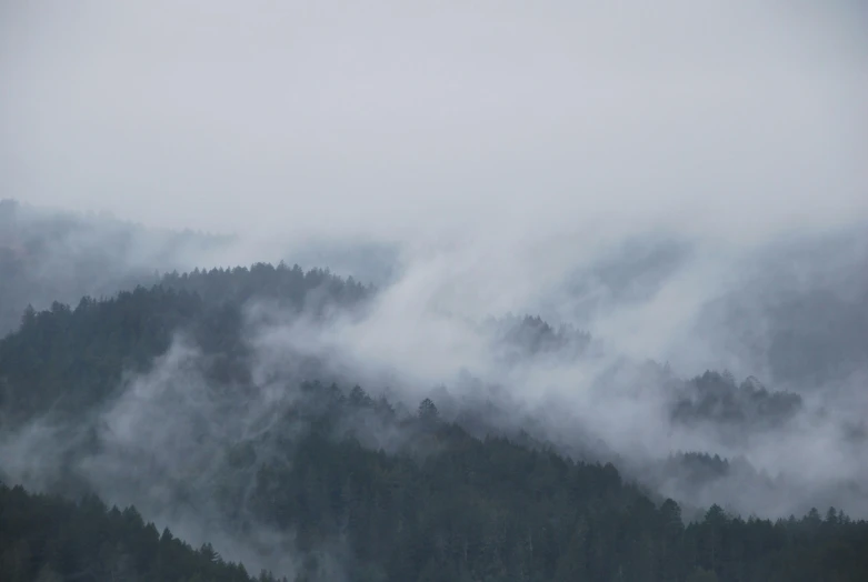 the mountains are covered with mist and low flying clouds