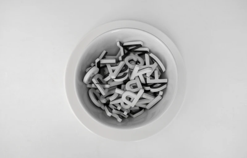 a bunch of typewriter letters in a bowl