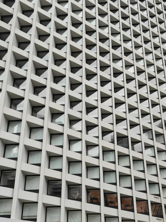 a building made out of cement that looks like it has holes in the side