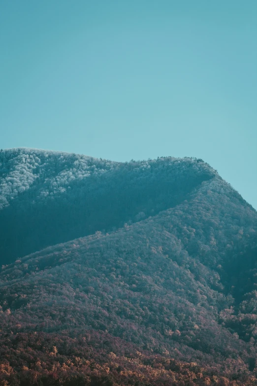 a group of mountains with a snow capped peak