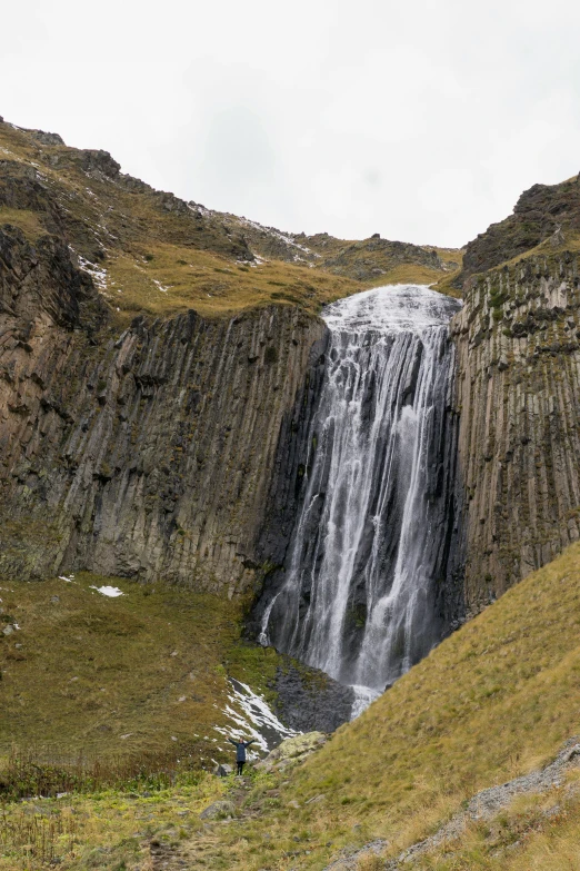 the top side of a mountain with a large waterfall