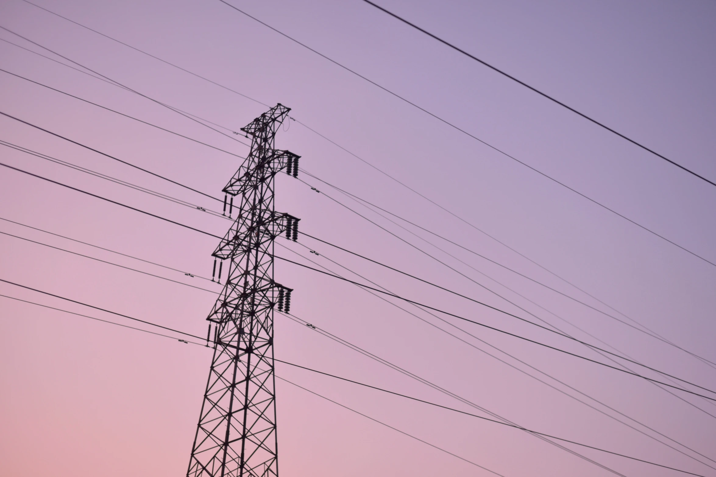 some large power lines high up against a sky