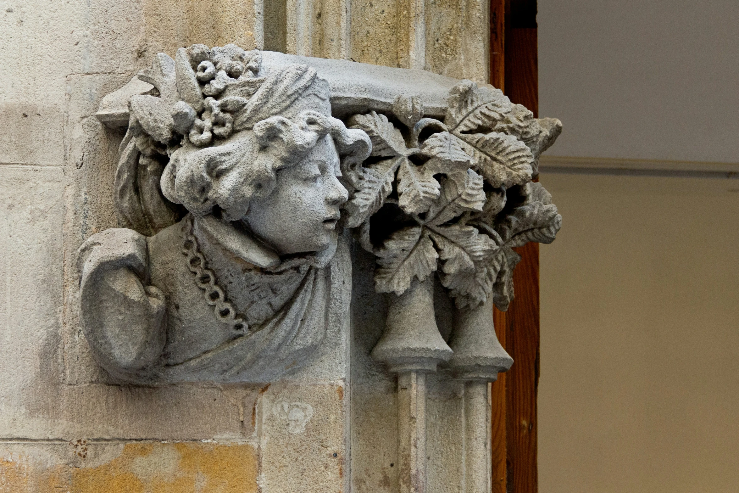 a decorative head on the side of a building