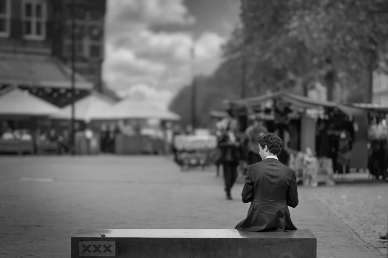 a person sitting on a bench talking on a cellphone