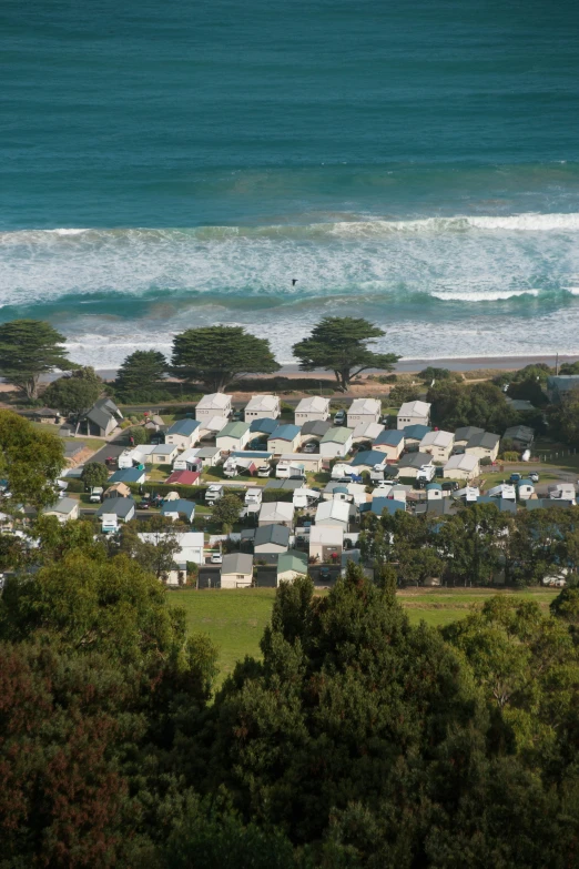 the beach and ocean are covered by many houses