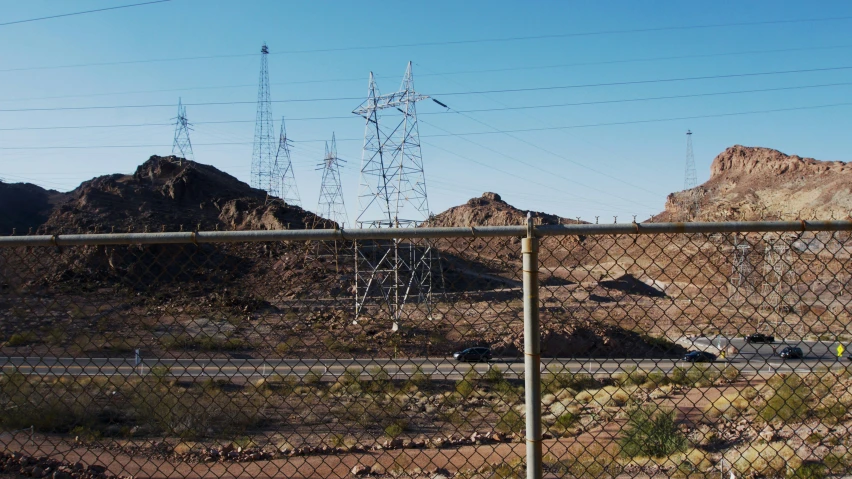 some mountains and telephone wires are in the foreground