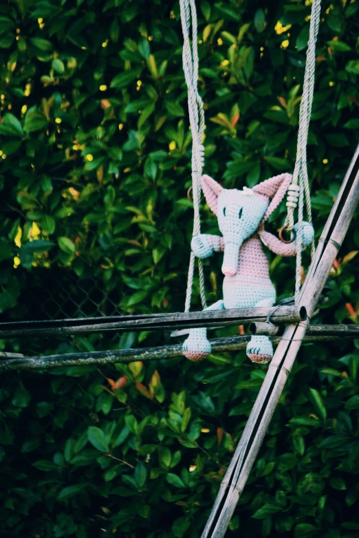 a stuffed animal is hanging in the air on a power line