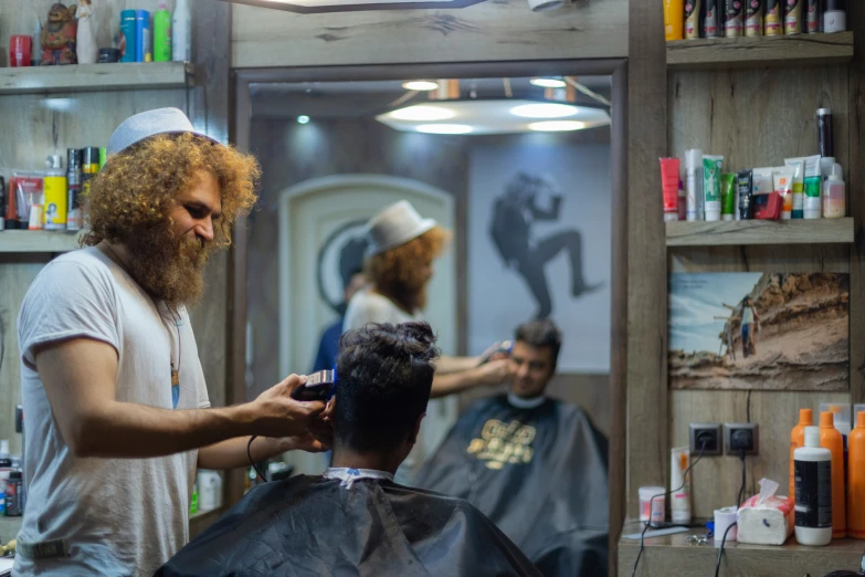 a man getting his hair styled by a barber