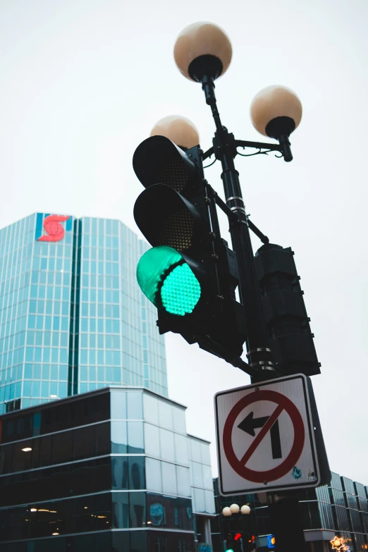 two stoplights hanging over a no turn sign