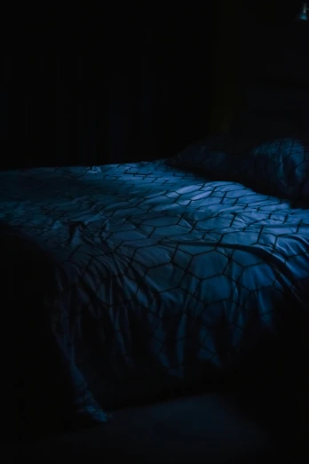 the bed is in the dark and it is shining blue
