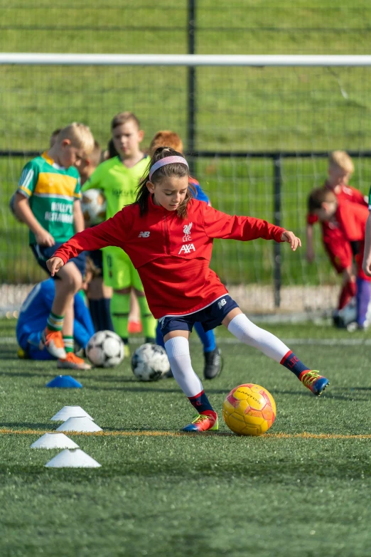 a  about to kick a ball during a soccer game