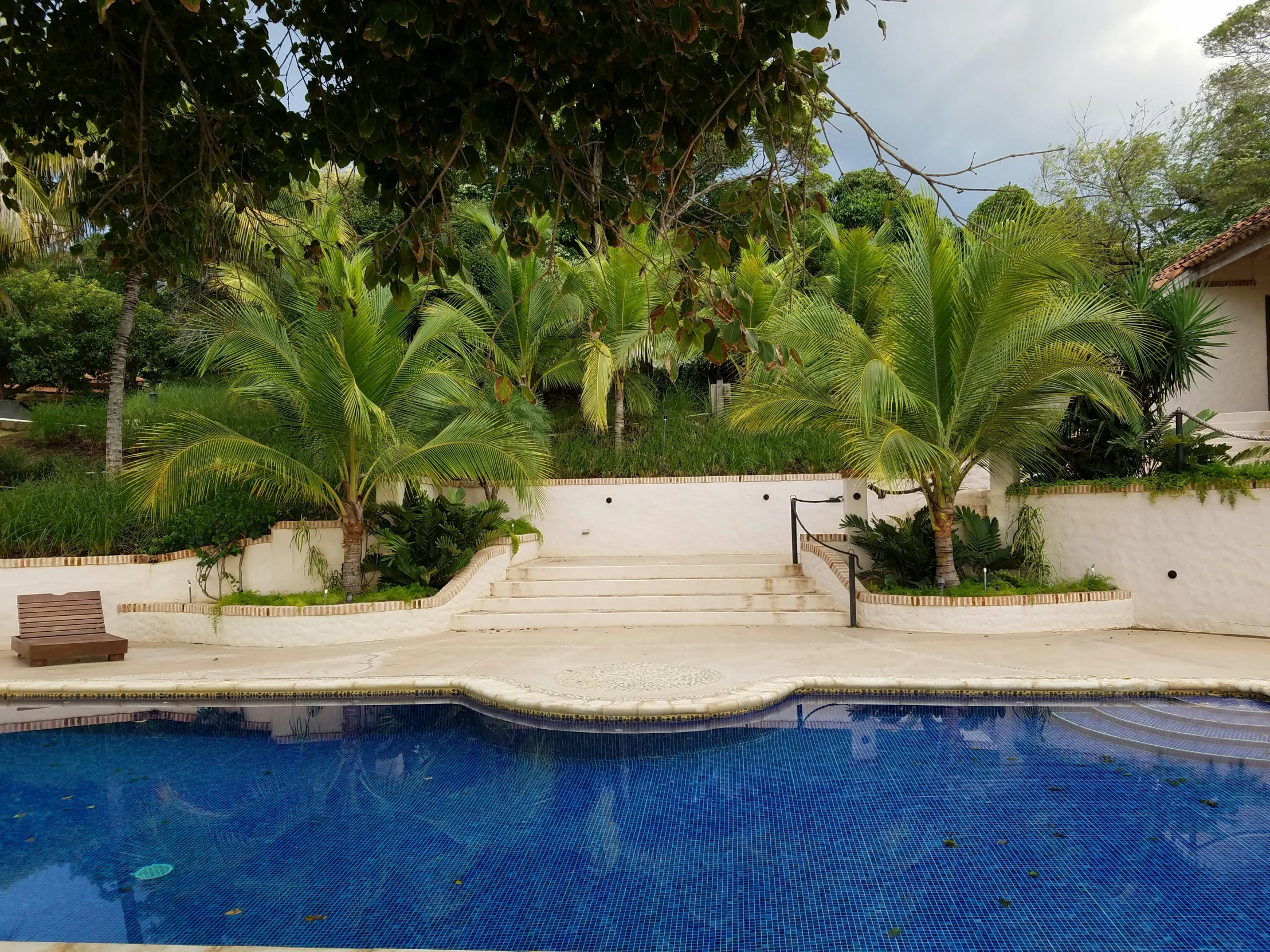 a pool with steps leading to the house