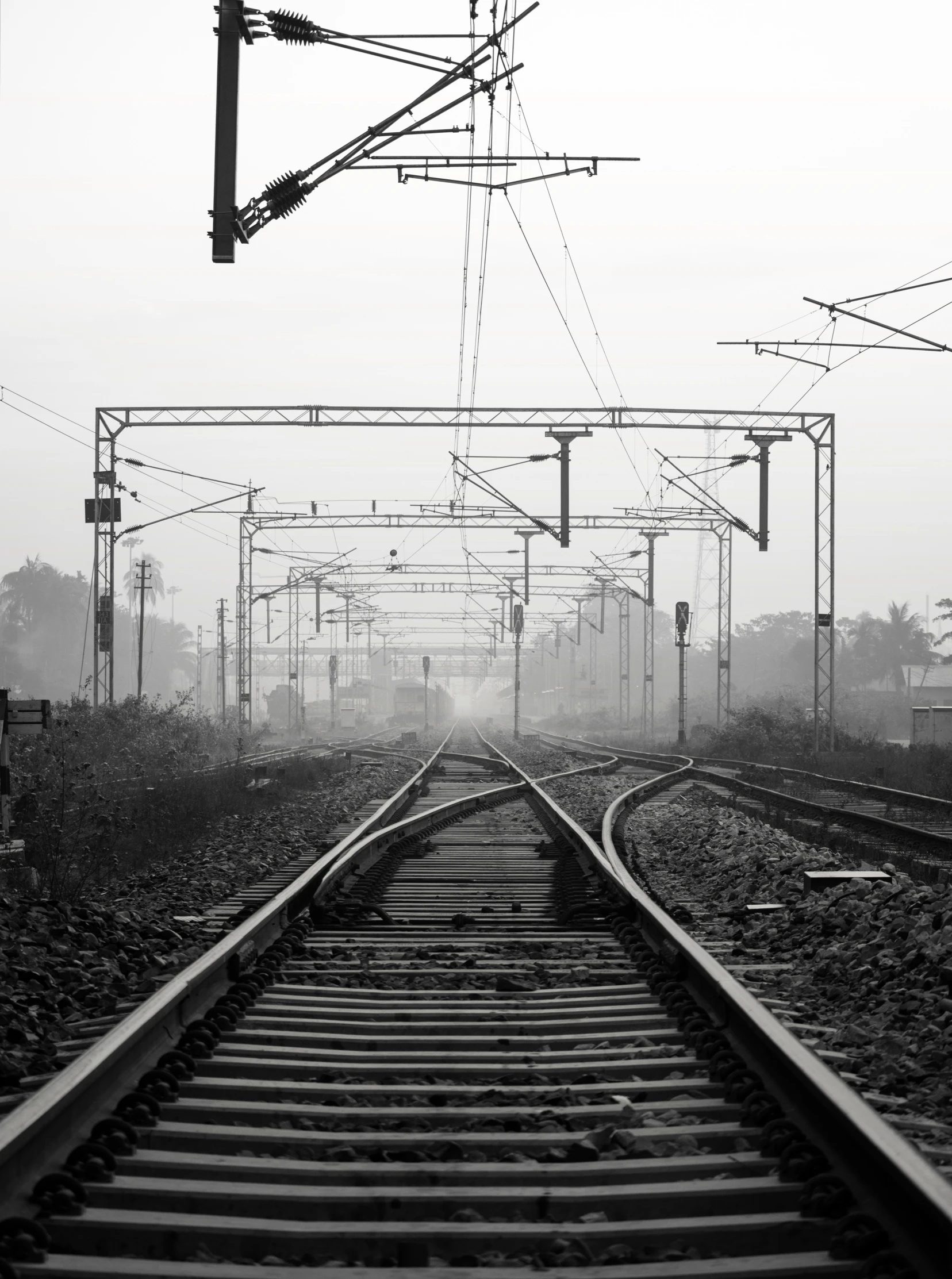 a train track running through a misty city