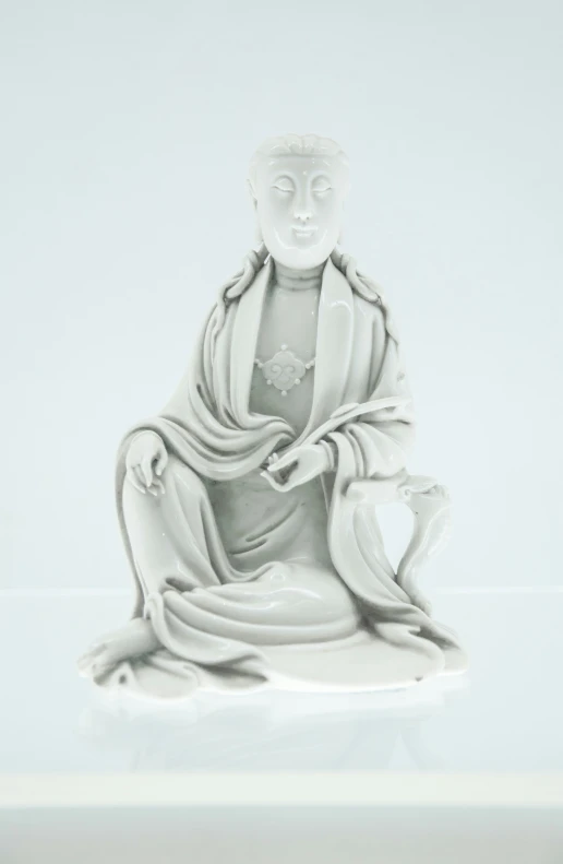 a statue that is sitting on a white surface