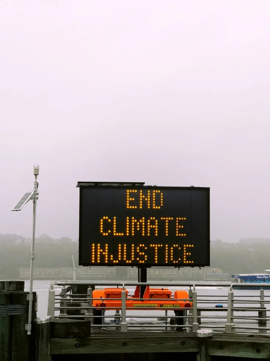 the sign says end climate in substance