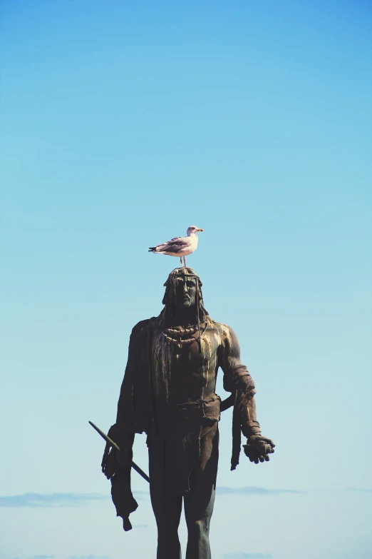 a statue with two birds perched on top of it