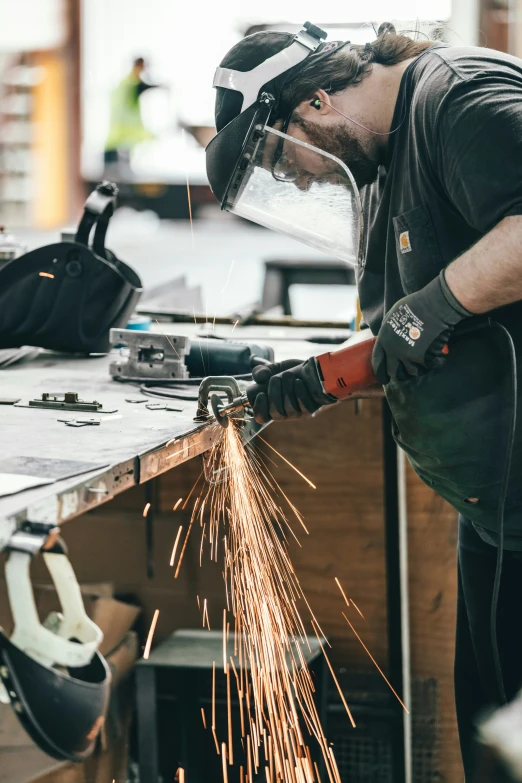 welder is  metal with safety gear on a wooden table