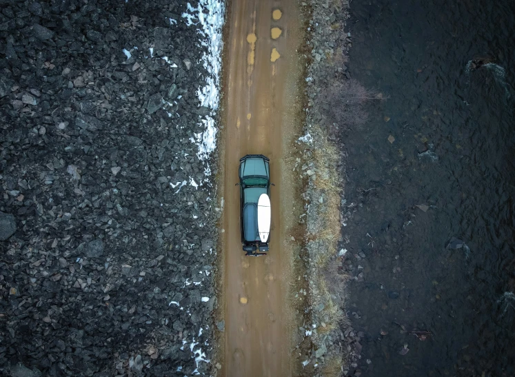 an aerial view of an automobile parked in the middle of a road