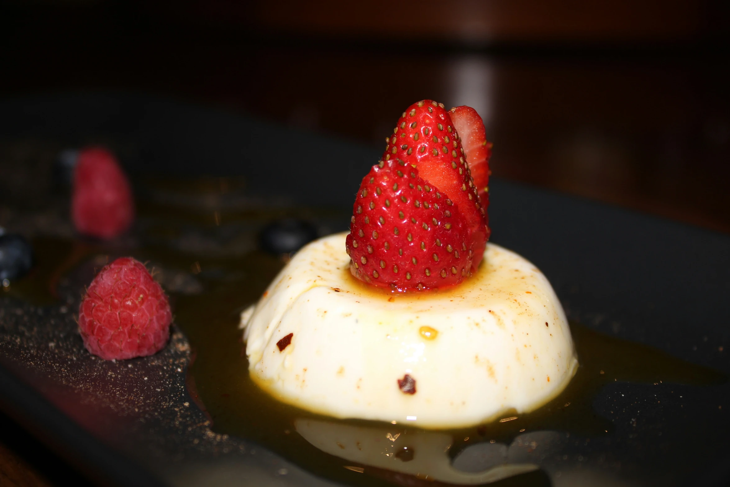 a dessert with a strawberry and some blueberries on top