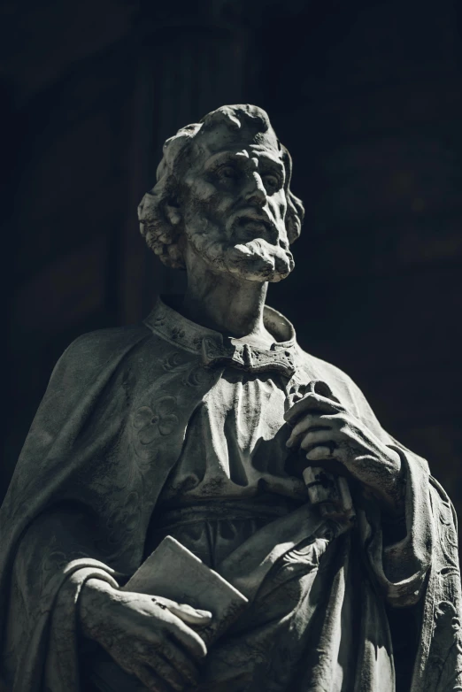 a statue with a cloak on it that is in a church