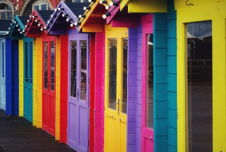 brightly colored wooden doors line the sides of a building