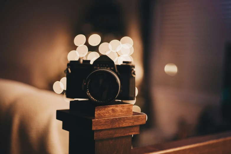 a digital camera sitting on a table with lights behind it