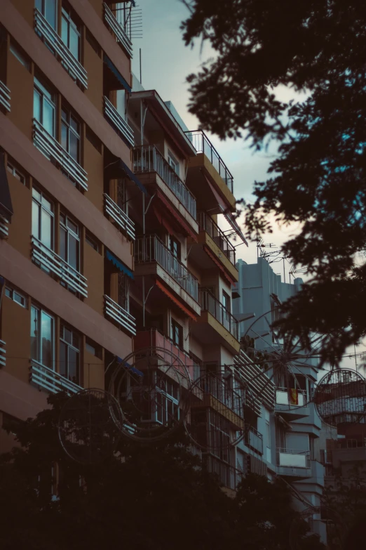 an apartment building with balconies, red and brown exterior