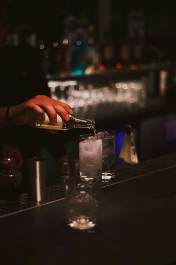 a bartender using a razor to cut into small pieces