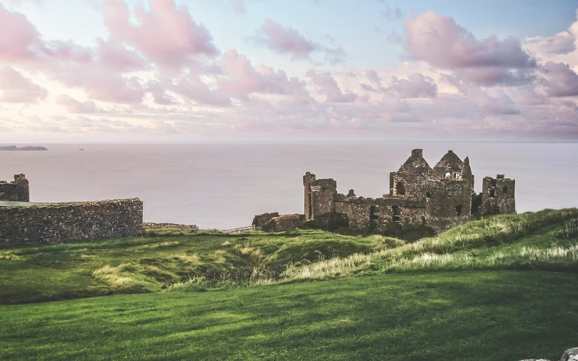 there is an old castle and the ocean below it