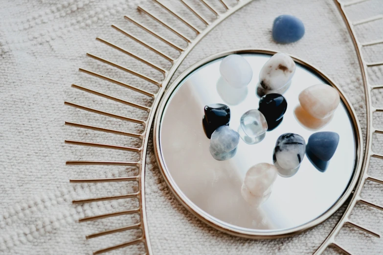 several stones in the shape of a heart on a mirror