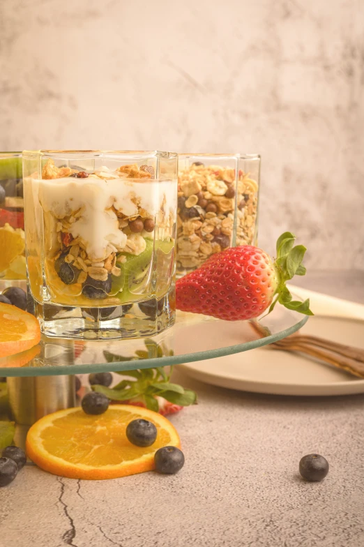 some fruits are on the table, with two glasses filled with them