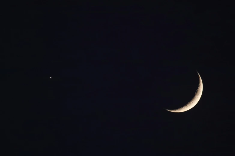 the moon seen through the telescope, in the dark sky