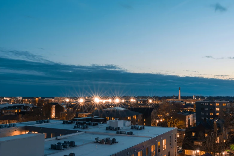 the city lights are on and buildings glow behind them