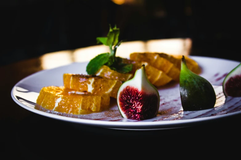 a white plate topped with fruit and slices of lemon