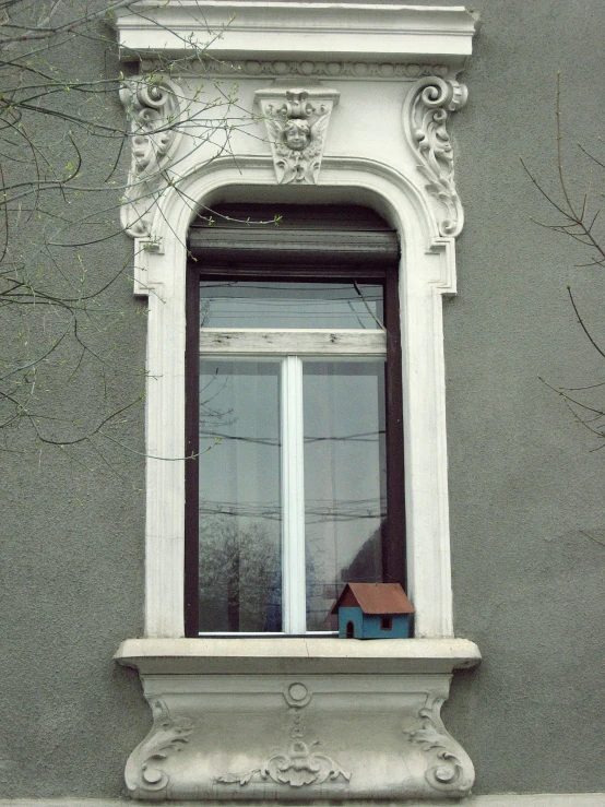 a window in a building with a toy house on it