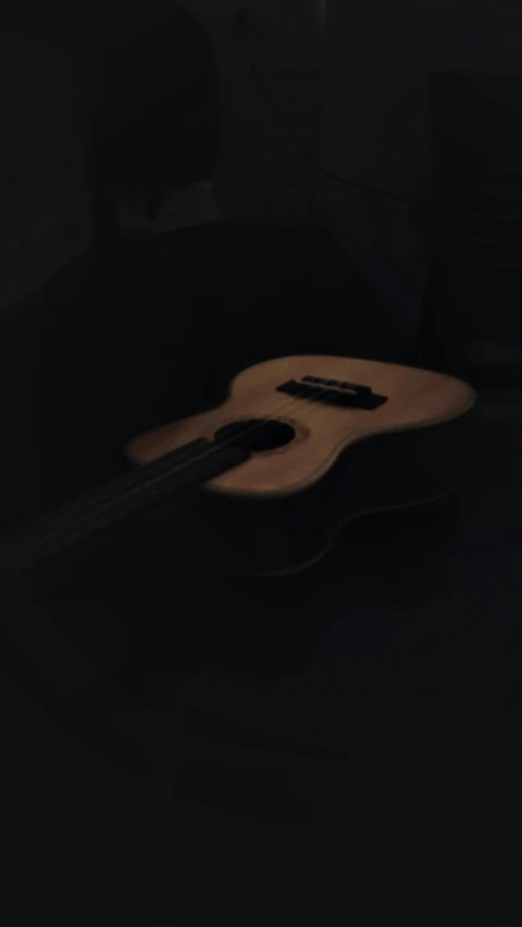 an acoustic guitar sitting on a desk