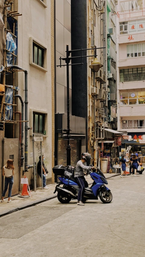 there is a man sitting on his bike in the street