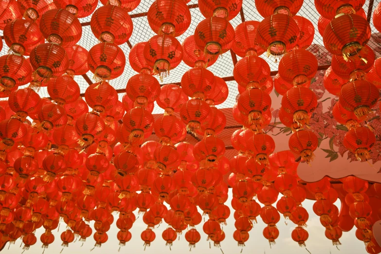 a view of a wall covered in red lanterns