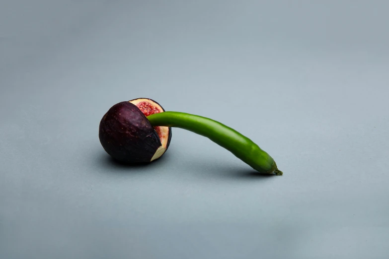 a piece of fruit with green leaf attached