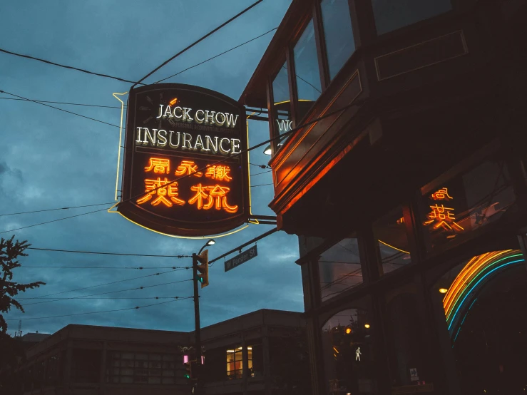 neon sign saying insurance above an asian restaurant