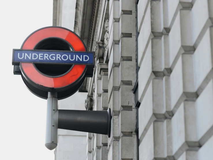 the underground sign hangs on the side of the building