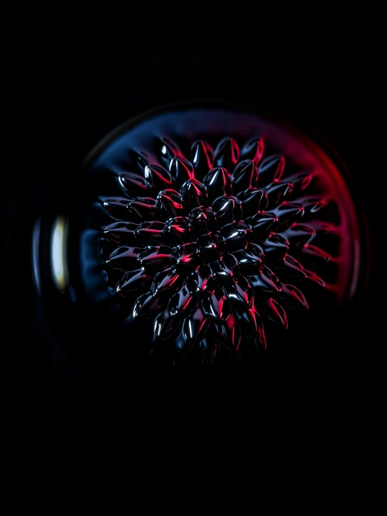 a very colorful flower placed in the center of a black bowl