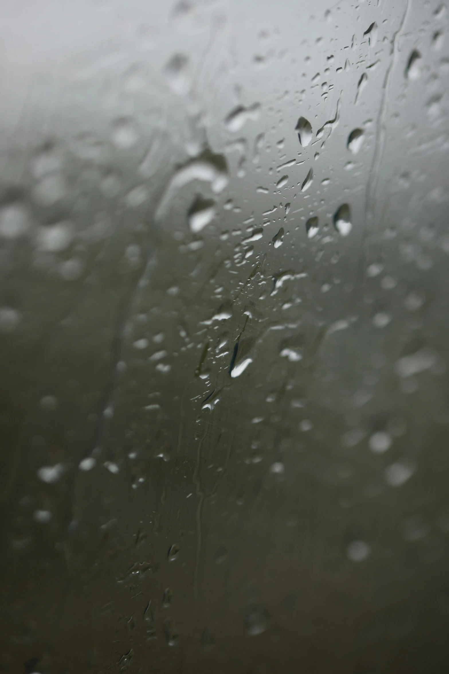 rain is seen on the window outside while it rains