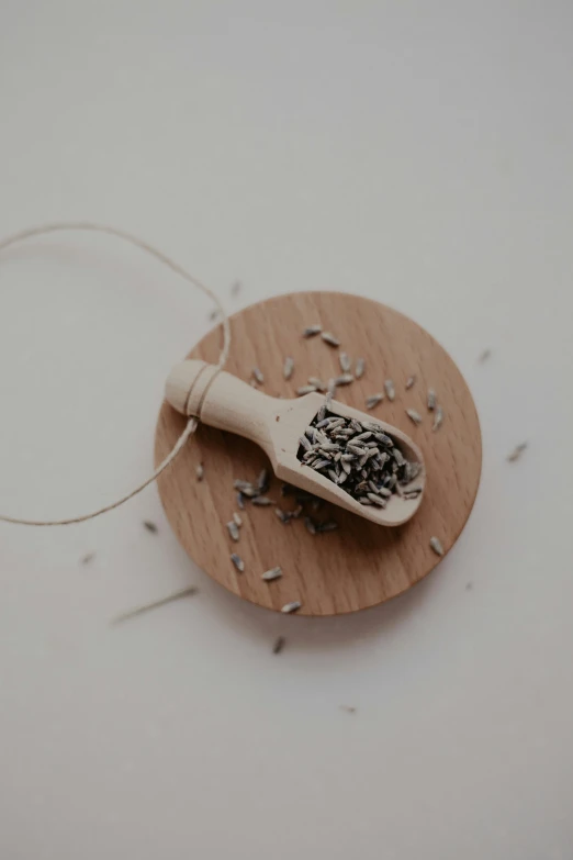 a wooden plate with a spatula and seeds