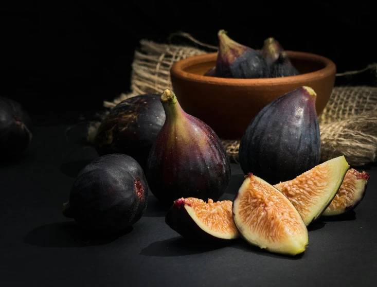 a pile of fresh figs cut up on a table